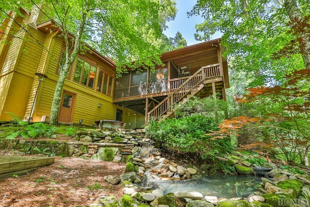 rear view of house featuring a sunroom