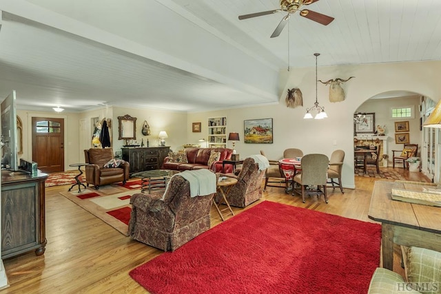 living room with ceiling fan with notable chandelier, light hardwood / wood-style flooring, and ornamental molding