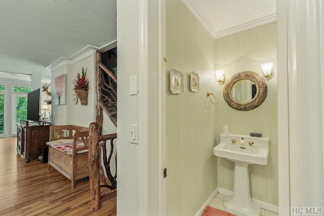 bathroom featuring ornamental molding and wood-type flooring