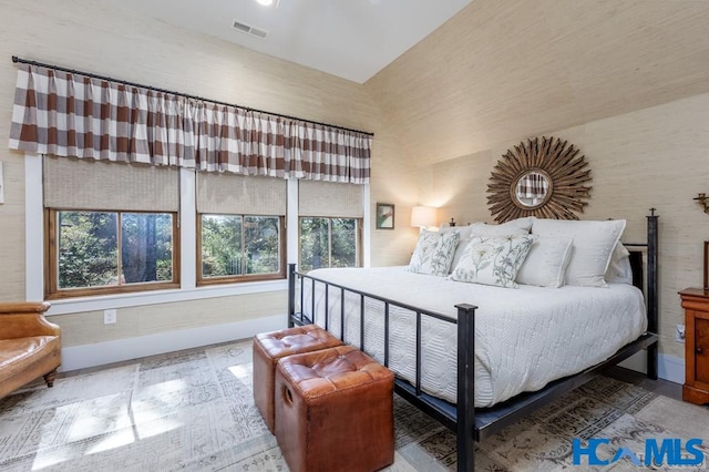 bedroom featuring baseboards and visible vents