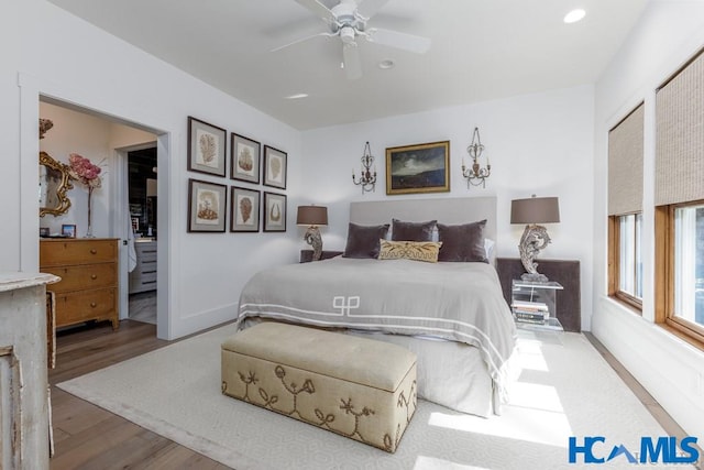 bedroom featuring recessed lighting, baseboards, wood finished floors, and a ceiling fan