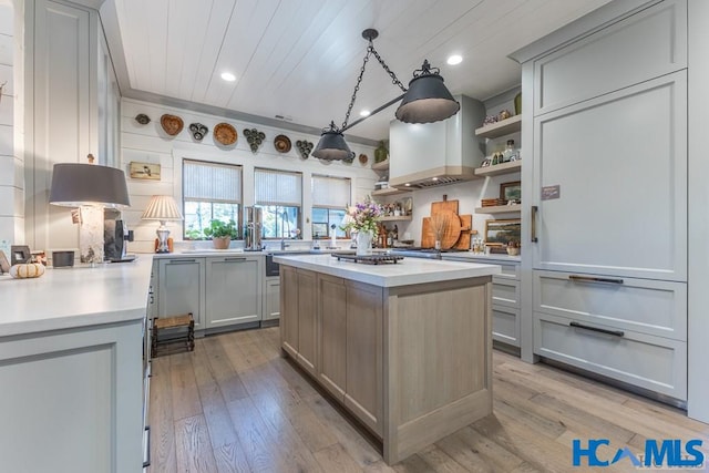 kitchen with open shelves, light wood-style flooring, light countertops, and gray cabinetry