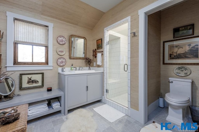 bathroom with tile patterned flooring, a shower stall, toilet, and vanity