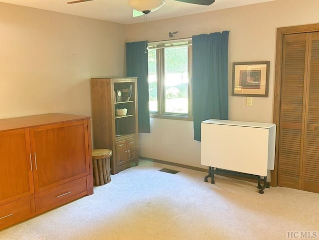 misc room with ceiling fan and light colored carpet