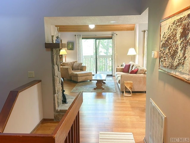 living room featuring light hardwood / wood-style flooring and a textured ceiling