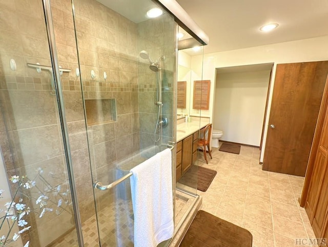 bathroom featuring walk in shower, tile patterned floors, vanity, and toilet