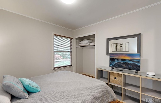 bedroom featuring ornamental molding and a closet