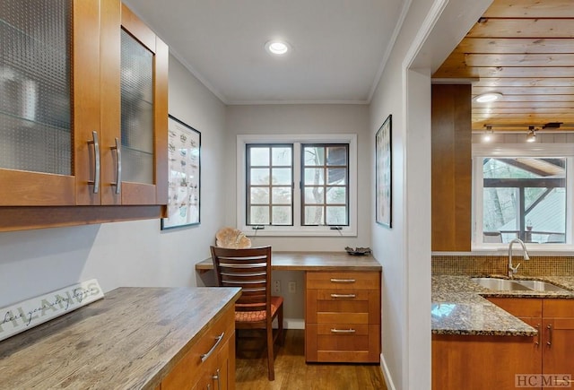 office space featuring sink, plenty of natural light, ornamental molding, and light wood-type flooring