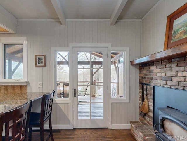 doorway to outside with beam ceiling and dark hardwood / wood-style floors