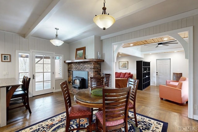 dining room featuring hardwood / wood-style flooring, beam ceiling, and french doors