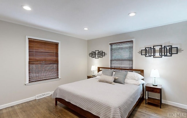 bedroom featuring ornamental molding and hardwood / wood-style floors