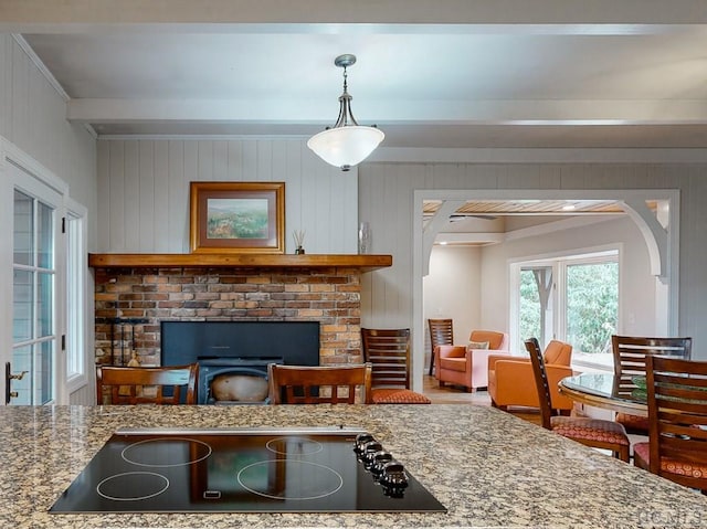 living room featuring beam ceiling and wood walls