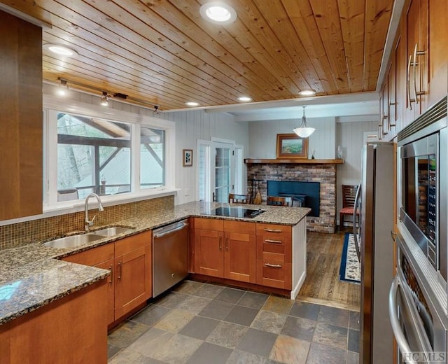 kitchen featuring sink, wood ceiling, appliances with stainless steel finishes, decorative light fixtures, and kitchen peninsula