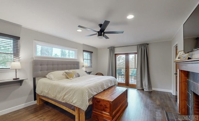 bedroom featuring dark wood-type flooring, a tile fireplace, ceiling fan, access to exterior, and ornamental molding