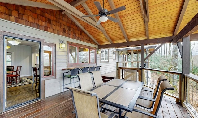 sunroom with vaulted ceiling with beams, wooden ceiling, and ceiling fan