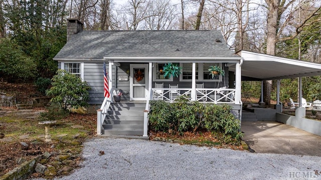 48 Holt Knob Rd, Highlands, NC 28741 - view of front of home featuring covered porch, a chimney, roof with shingles, and an attached carport