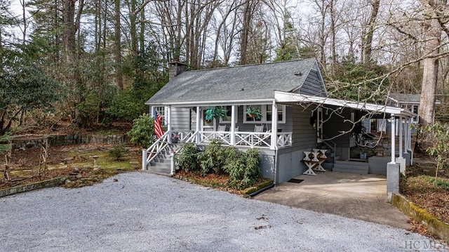48 Holt Knob Rd, Highlands, NC 28741 - view of front of property featuring a porch, a chimney, and a shingled roof