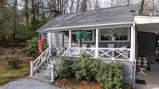 48 Holt Knob Rd, Highlands, NC 28741 - view of front of property with covered porch, a chimney, and roof with shingles
