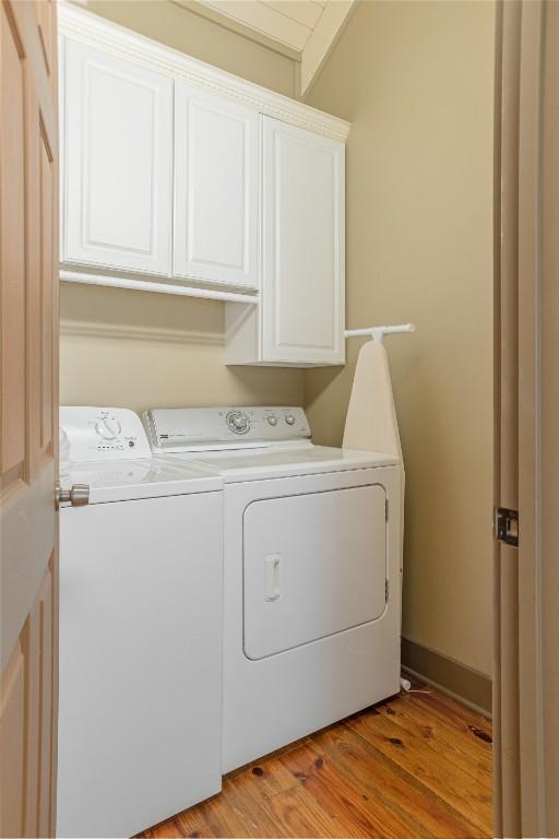 61 Indian Falls Way, Lake Toxaway, NC 28747 - laundry room with washer and clothes dryer, cabinet space, and light wood-style floors