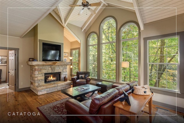 61 Indian Falls Way, Lake Toxaway, NC 28747 - living room featuring hardwood / wood-style floors, a ceiling fan, a stone fireplace, high vaulted ceiling, and beam ceiling