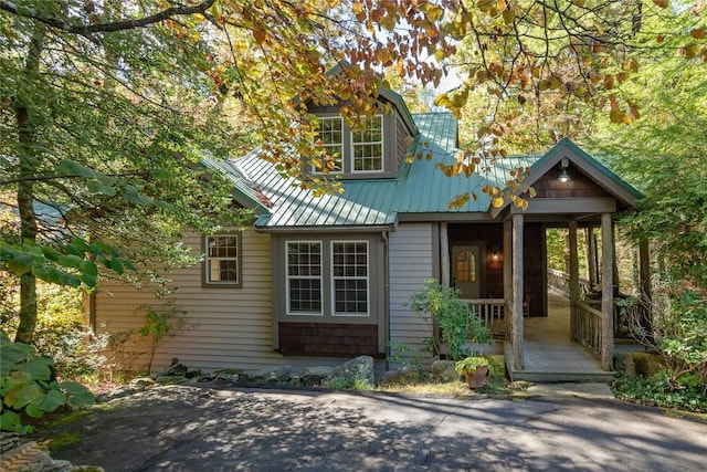 61 Indian Falls Way, Lake Toxaway, NC 28747 - view of front of house featuring covered porch, a metal roof, and a standing seam roof