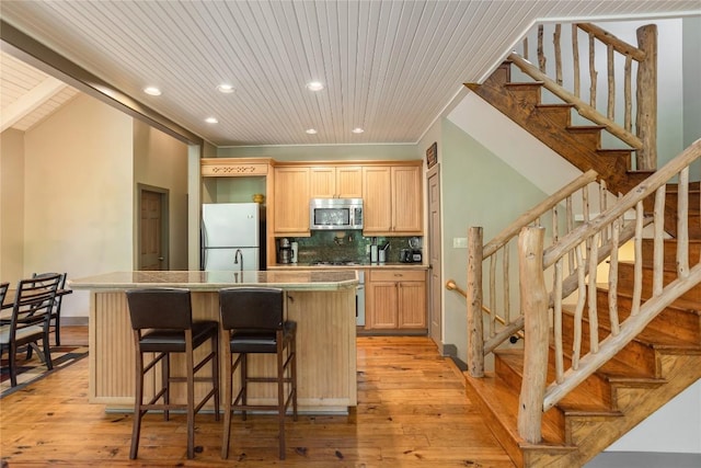 61 Indian Falls Way, Lake Toxaway, NC 28747 - kitchen featuring stainless steel appliances, recessed lighting, light brown cabinets, decorative backsplash, and a kitchen island