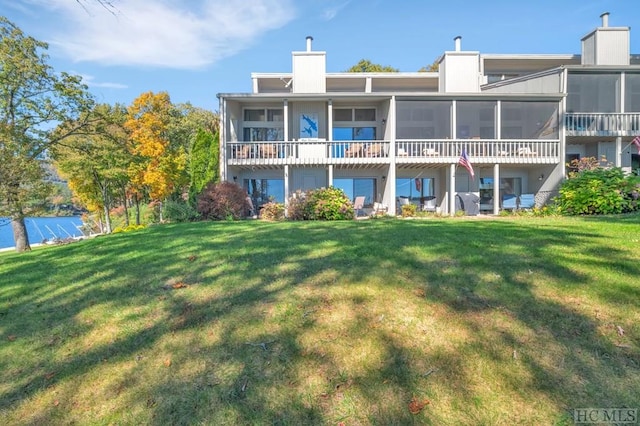 rear view of house with a lawn