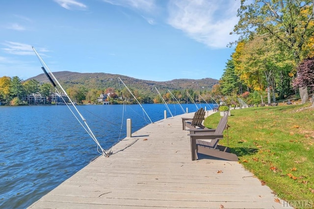 view of dock featuring a water and mountain view