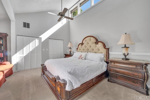 carpeted bedroom featuring a textured ceiling, high vaulted ceiling, and ceiling fan