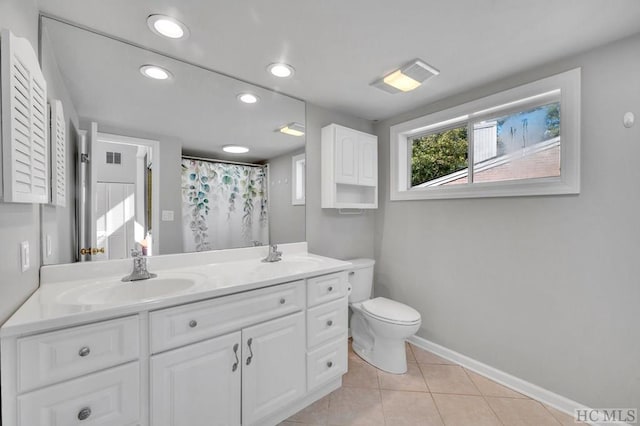 bathroom with vanity, curtained shower, tile patterned floors, and toilet