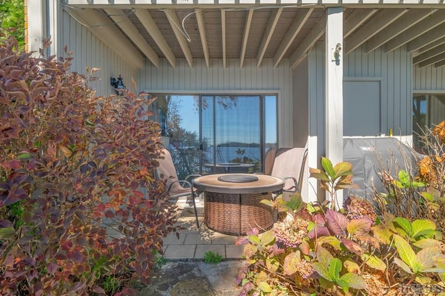 view of patio featuring central AC and an outdoor fire pit