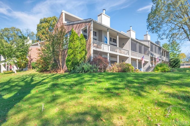 rear view of house with a lawn