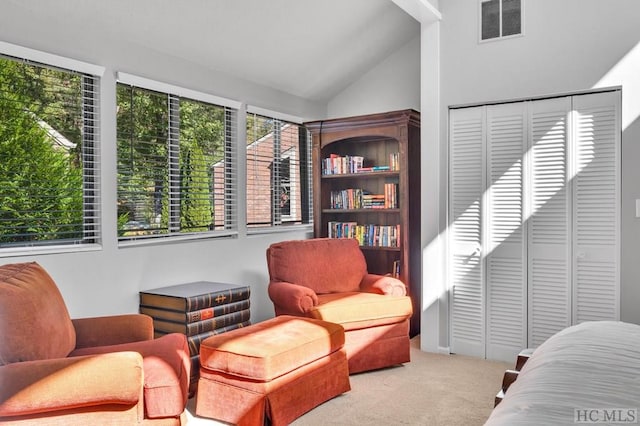 living area with lofted ceiling and light carpet