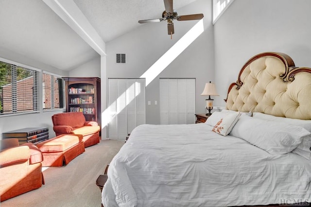 carpeted bedroom featuring multiple windows, high vaulted ceiling, and ceiling fan