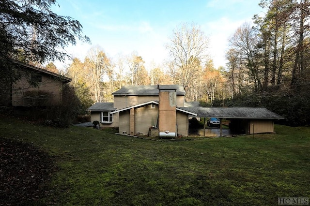 rear view of property featuring a yard