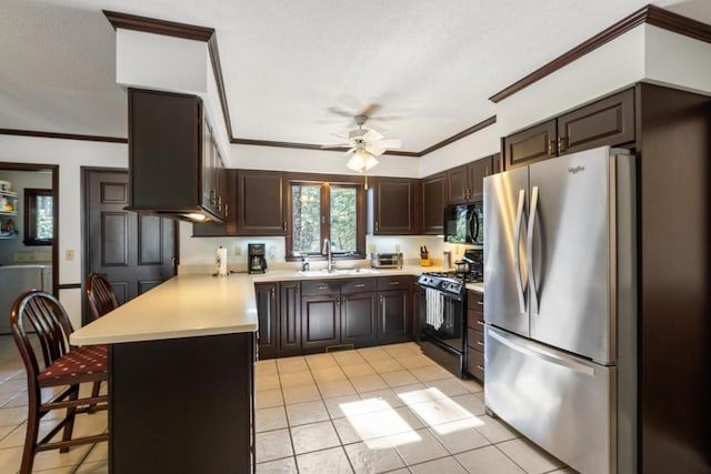 776 Stillmont Cir, Cashiers, NC 28717 - kitchen featuring a sink, light countertops, black appliances, and a peninsula