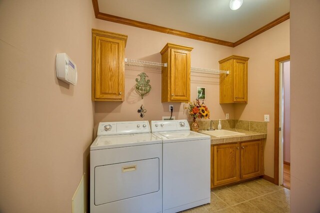 11 Lower Tanglewood Dr E, Lake Toxaway, NC 28747 - laundry area featuring washing machine and dryer, a sink, ornamental molding, and cabinet space