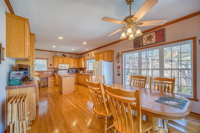 11 Lower Tanglewood Dr E, Lake Toxaway, NC 28747 - dining area with crown molding, ceiling fan, light wood-style flooring, and a healthy amount of sunlight