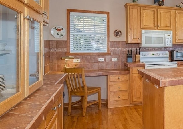 11 Lower Tanglewood Dr E, Lake Toxaway, NC 28747 - kitchen featuring white appliances, light wood finished floors, backsplash, tile countertops, and a toaster