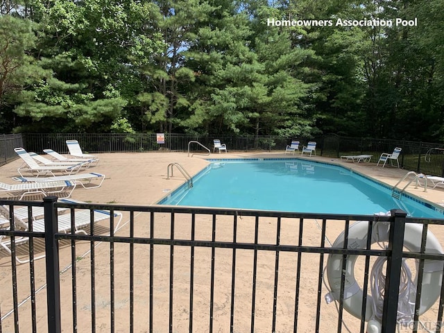 11 Lower Tanglewood Dr E, Lake Toxaway, NC 28747 - community pool featuring a patio and fence