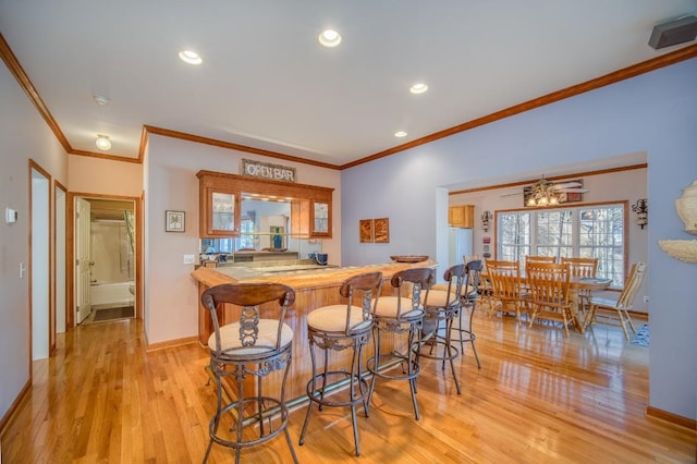 11 Lower Tanglewood Dr E, Lake Toxaway, NC 28747 - bar with baseboards, recessed lighting, light wood-type flooring, and crown molding