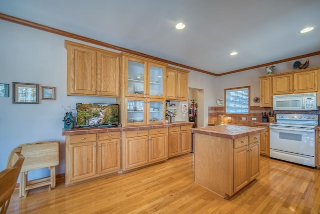 11 Lower Tanglewood Dr E, Lake Toxaway, NC 28747 - kitchen featuring light wood-style floors, tile countertops, white appliances, ornamental molding, and backsplash