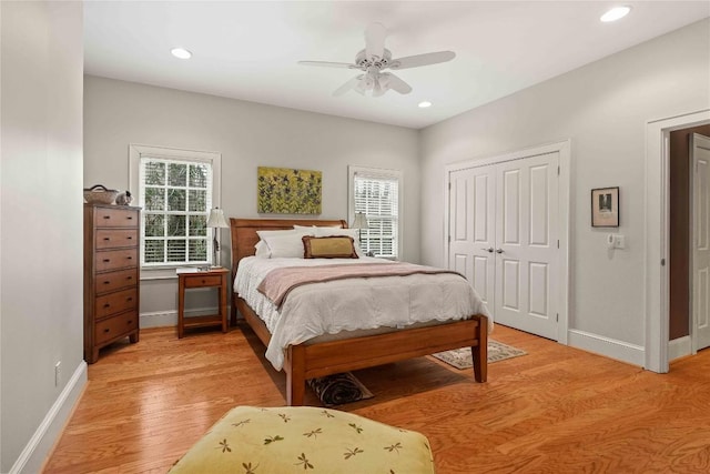 bedroom featuring recessed lighting, baseboards, light wood-type flooring, and a closet