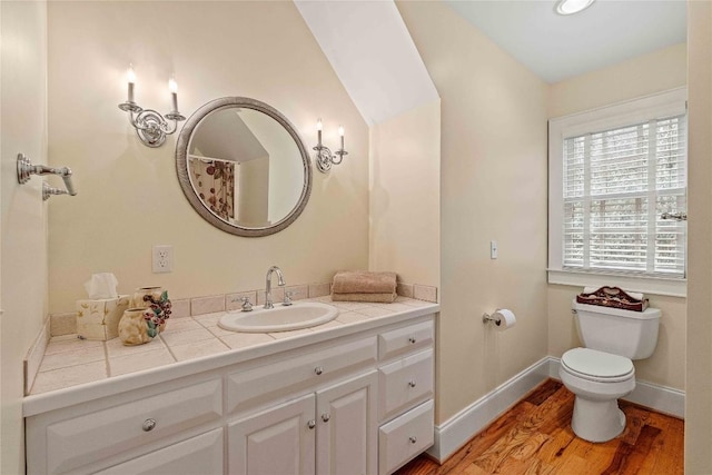 full bath featuring vanity, toilet, wood finished floors, and baseboards