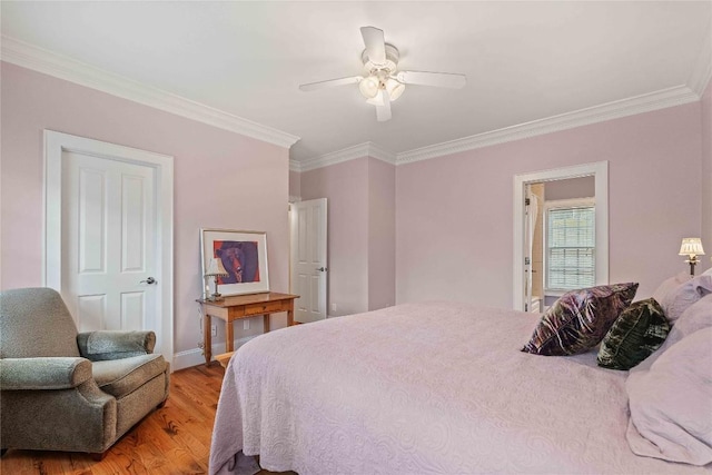 bedroom featuring a ceiling fan, baseboards, light wood finished floors, and ornamental molding