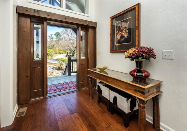 entrance foyer featuring dark wood finished floors and baseboards