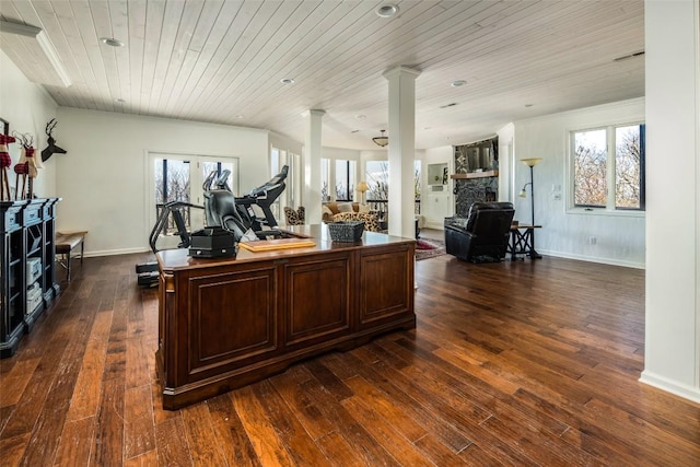 home office with ornate columns, wood ceiling, a fireplace, dark wood-style floors, and healthy amount of natural light