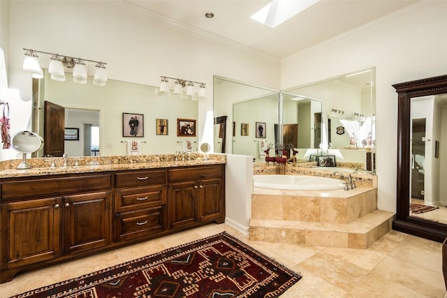 full bath with a skylight, a bath, ornamental molding, and double vanity