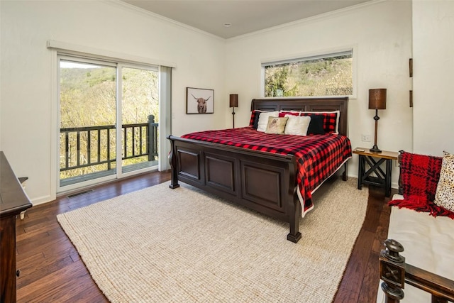 bedroom with access to outside, multiple windows, wood finished floors, and crown molding