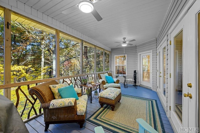 sunroom / solarium featuring ceiling fan